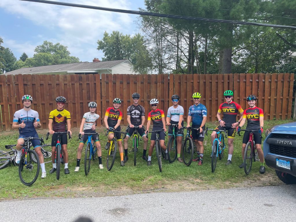 Photograph of ten people on bikes standing in a line