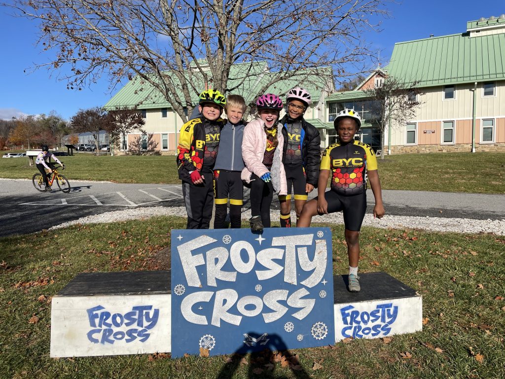 Photograph of five kids standing on the Frosty Cross podium