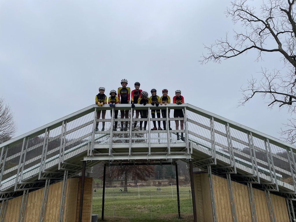 Photo of eight kids in BYC kit posing on top of a flyover